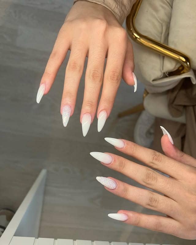 13. Milky White Stiletto Nails with Glitter Accent - milky nail ideas