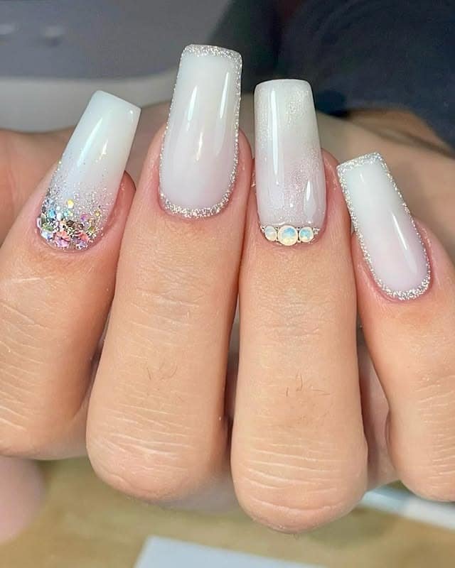 16. Milky White Glam Coffin Nails with Rhinestones - milky nail ideas