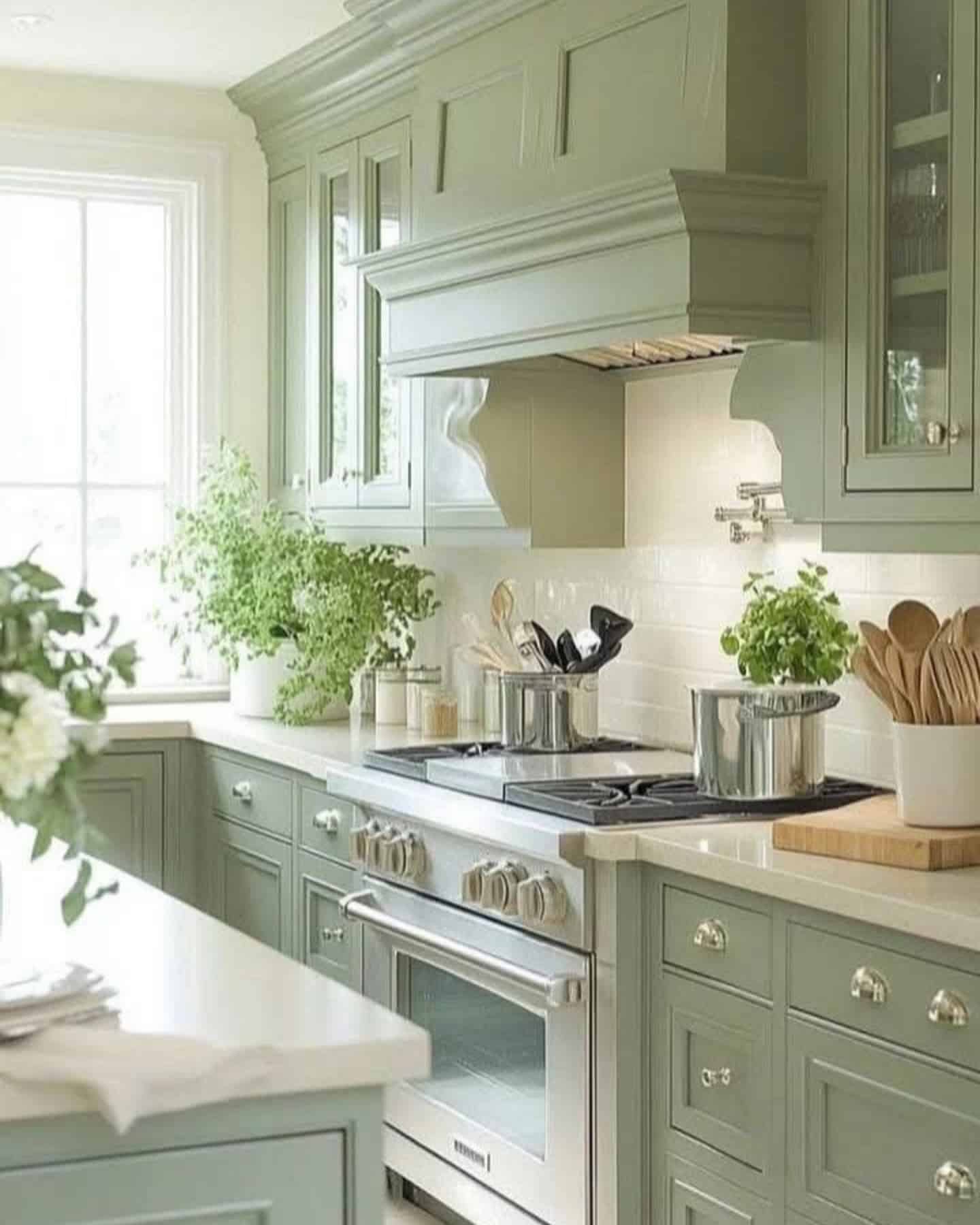 12. Classic Sage Green Kitchen With Decorative Hood - sage green kitchen ideas