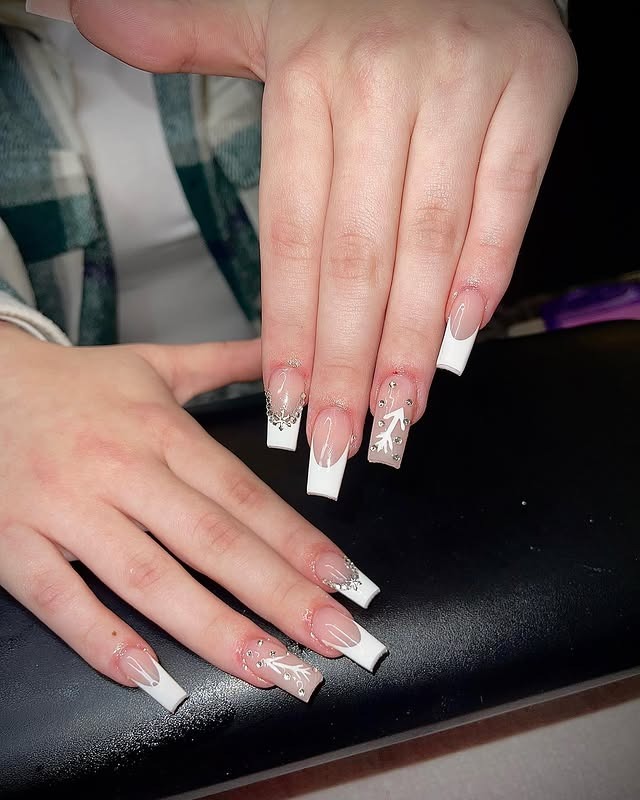 5. White French Tip Snowflake Glam Nails - winter birthday nail ideas