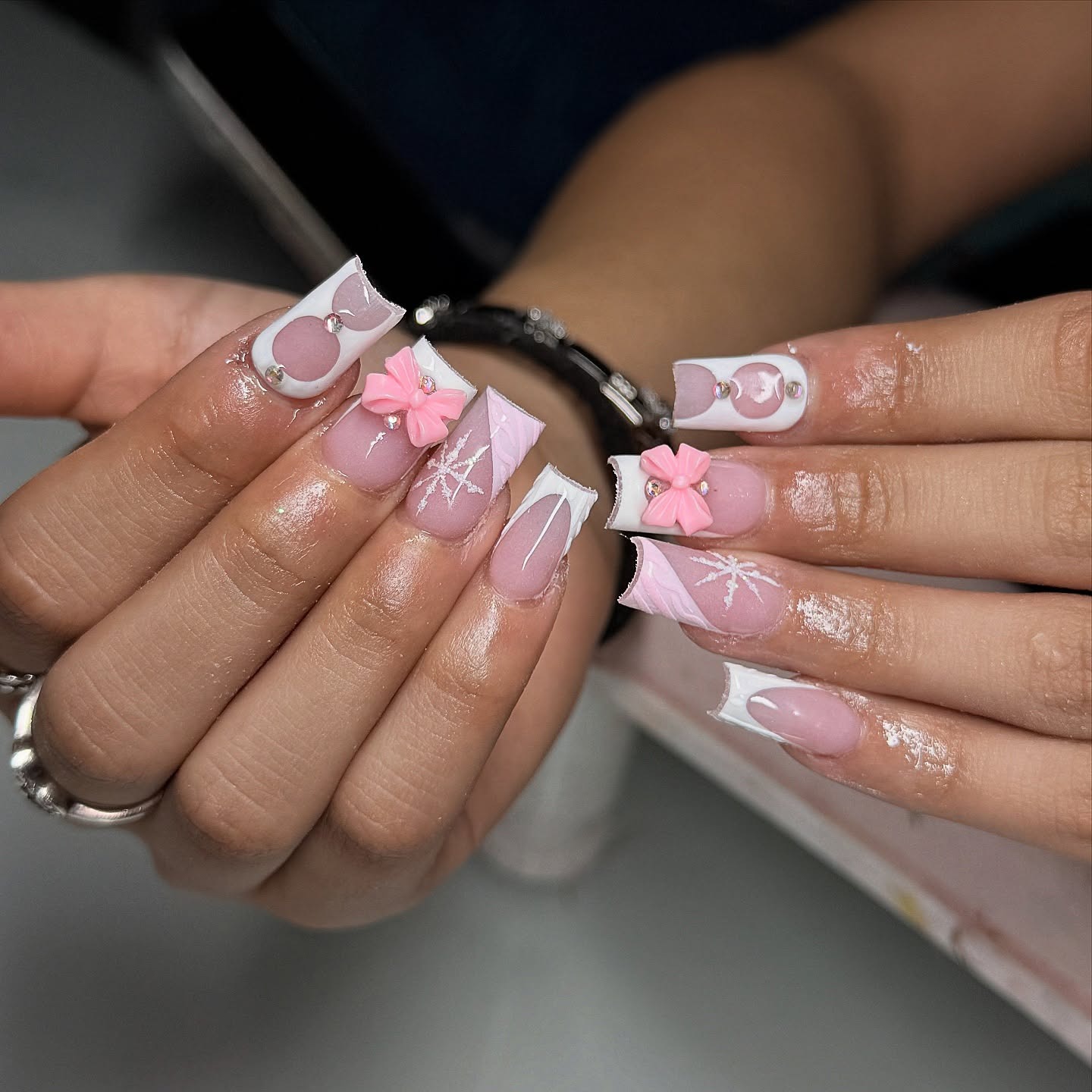 15. Pink Flower and Snowflake French Tip Nails - winter birthday nail ideas