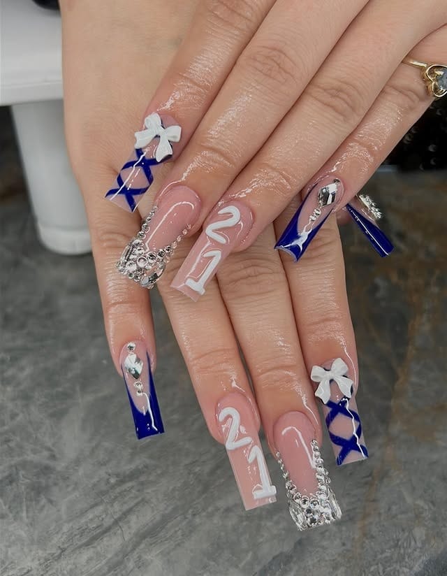 17. Royal Blue Bow and Candy Cane Coffin Nails - winter birthday nail ideas