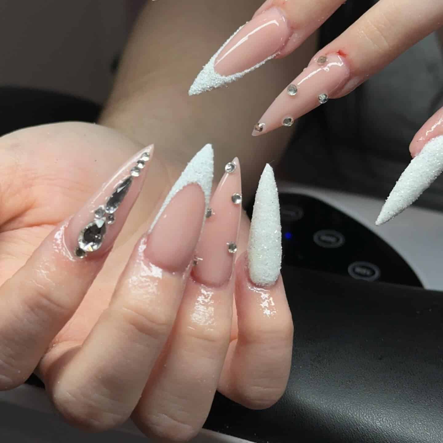 18. Nude Pink Sugar Stiletto Nails with Rhinestones - winter birthday nail ideas
