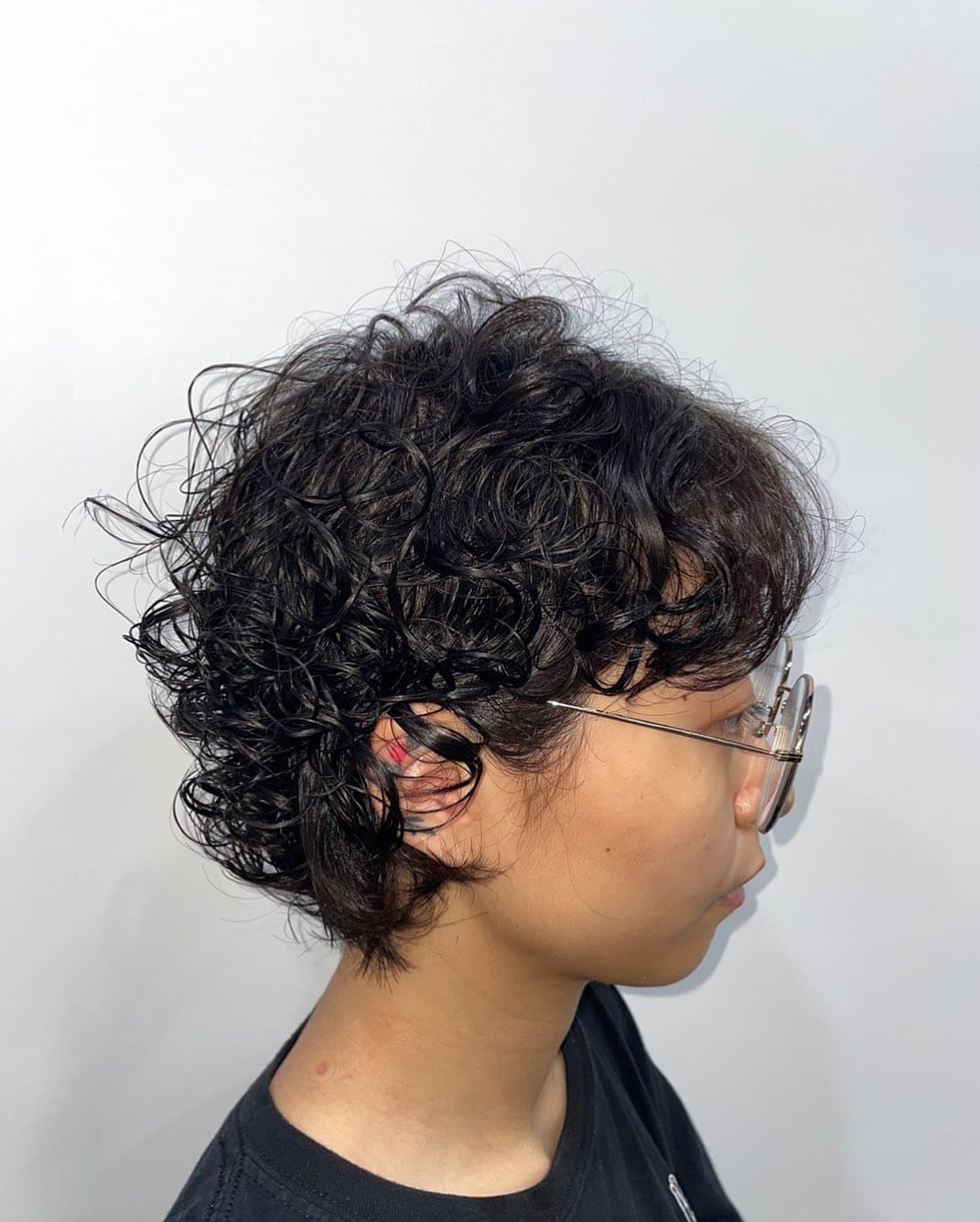 5. Curly Pixie Bob with Jet Black Hair - Short Hippie Hairstyles