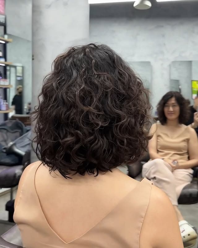 6. Rounded Curly Bob with Dark Chocolate Brown Hair - Short Hippie Hairstyles