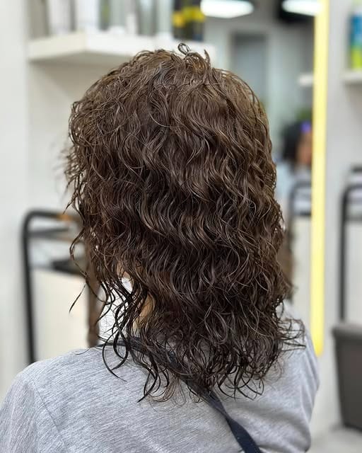 11. Layered Curly Shag with Medium Ash Brown Hair - Short Hippie Hairstyles
