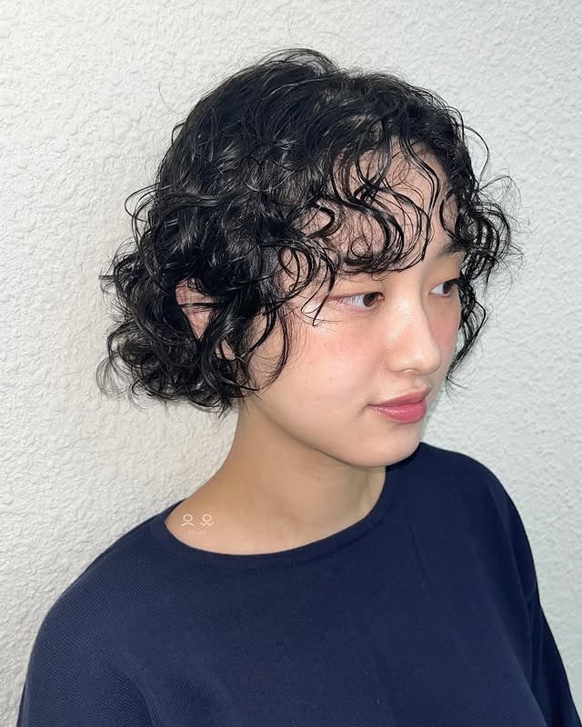 18. Curly Micro Bob with Deep Black Hair - Short Hippie Hairstyles