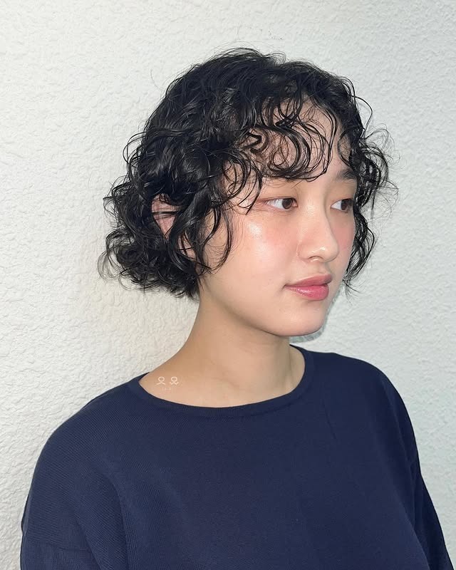 21. Curly Micro Bob with Natural Black Hair - Short Hippie Hairstyles