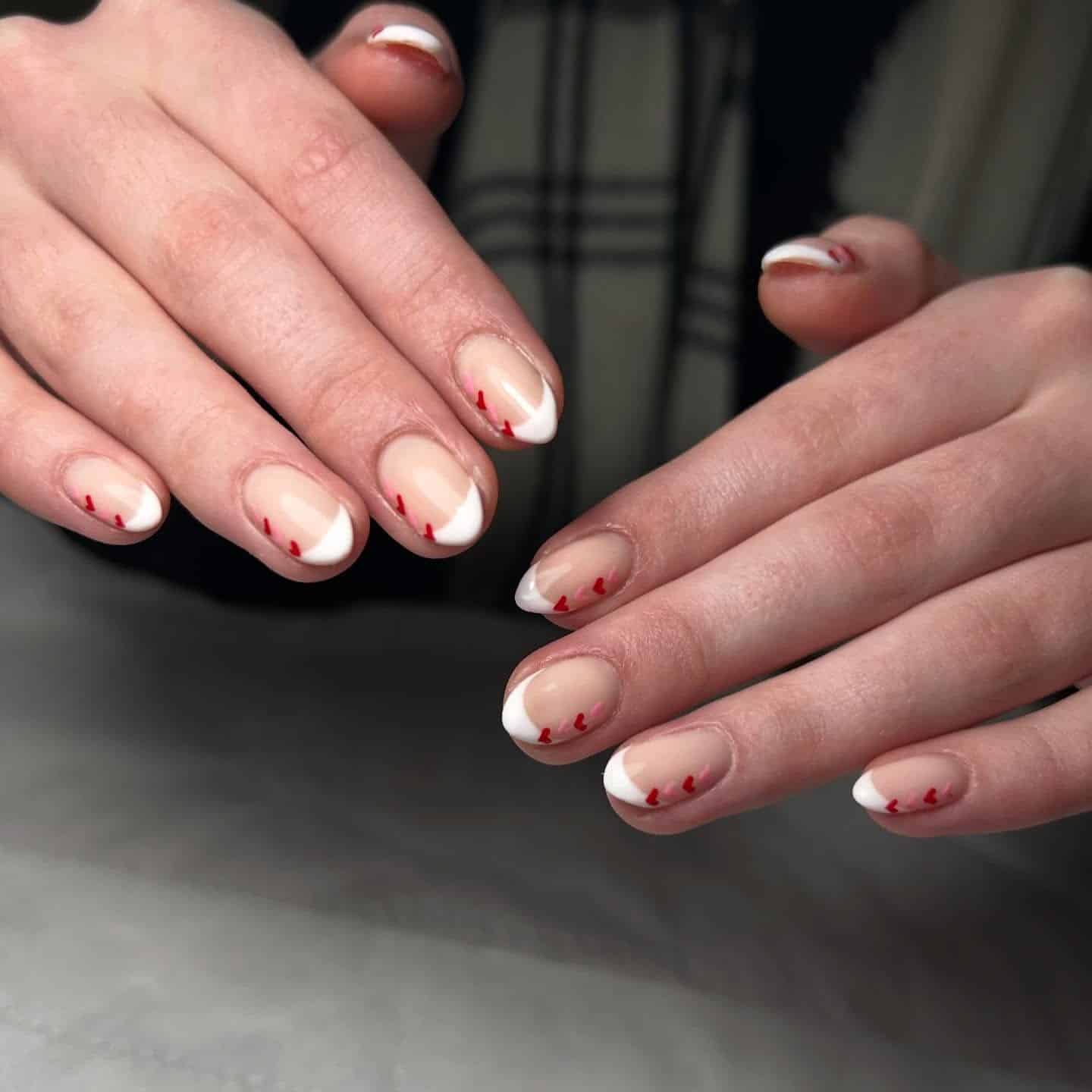 11. White French Manicure with Red Heart Accents - french-manicure-nail-ideas