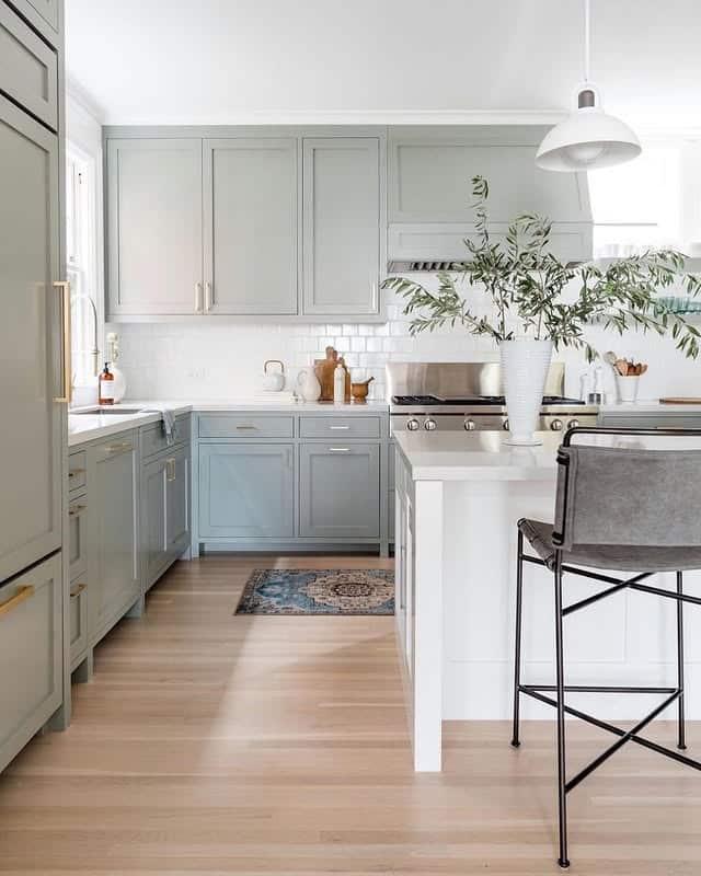 2. Sage Gray Kitchen with Light Wood Flooring - gray kitchen ideas