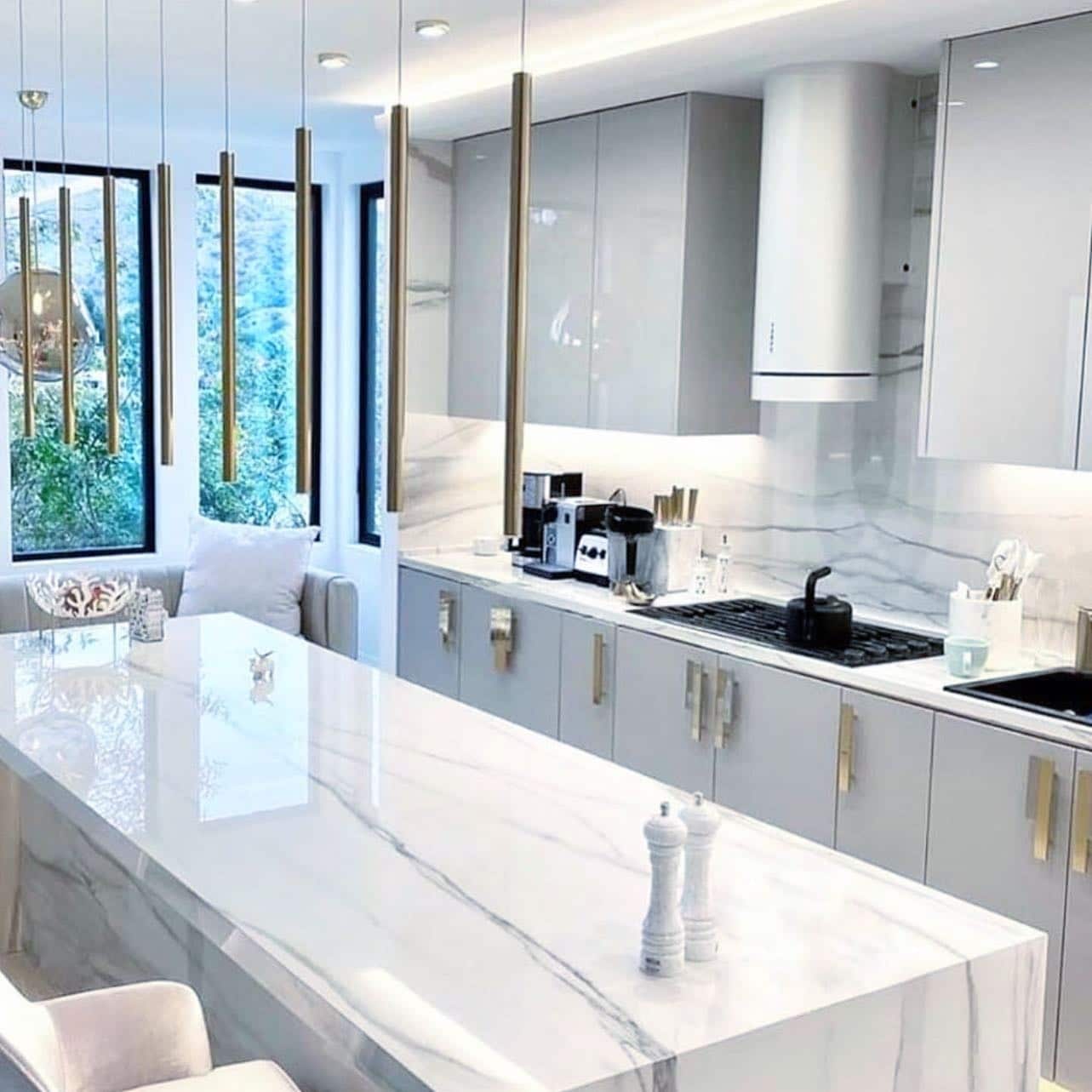 4. Modern Gray Kitchen with Marble Waterfall Island - gray kitchen ideas