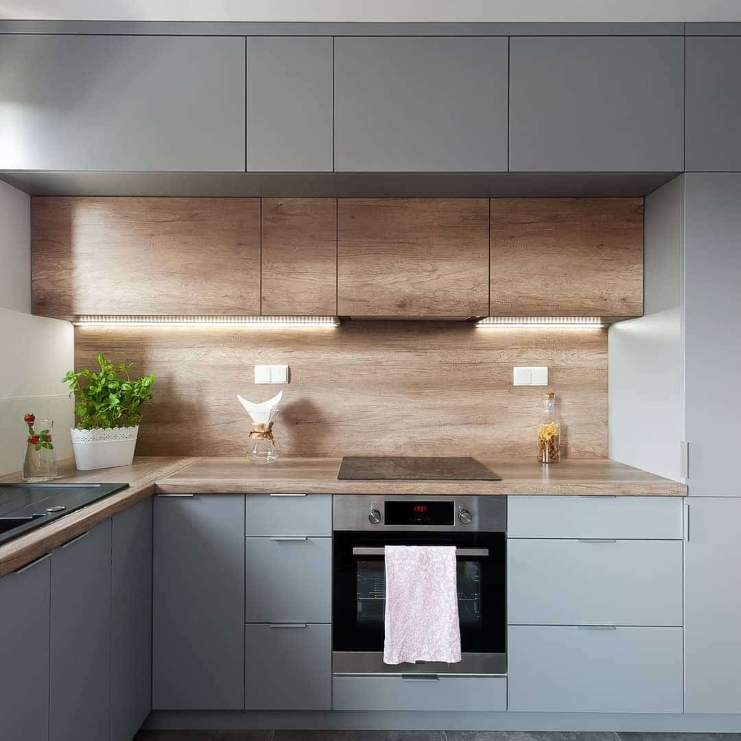 22. Modern Gray Kitchen with Wood Accent Backsplash - gray kitchen ideas