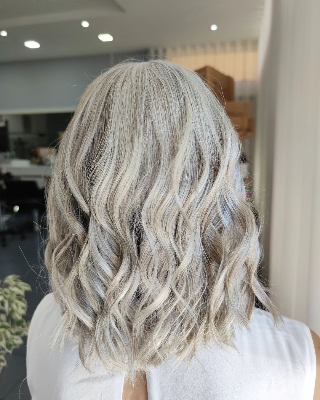 15. Frosted Icy Blonde Shoulder-Length Waves - Icy Blonde Hair Color