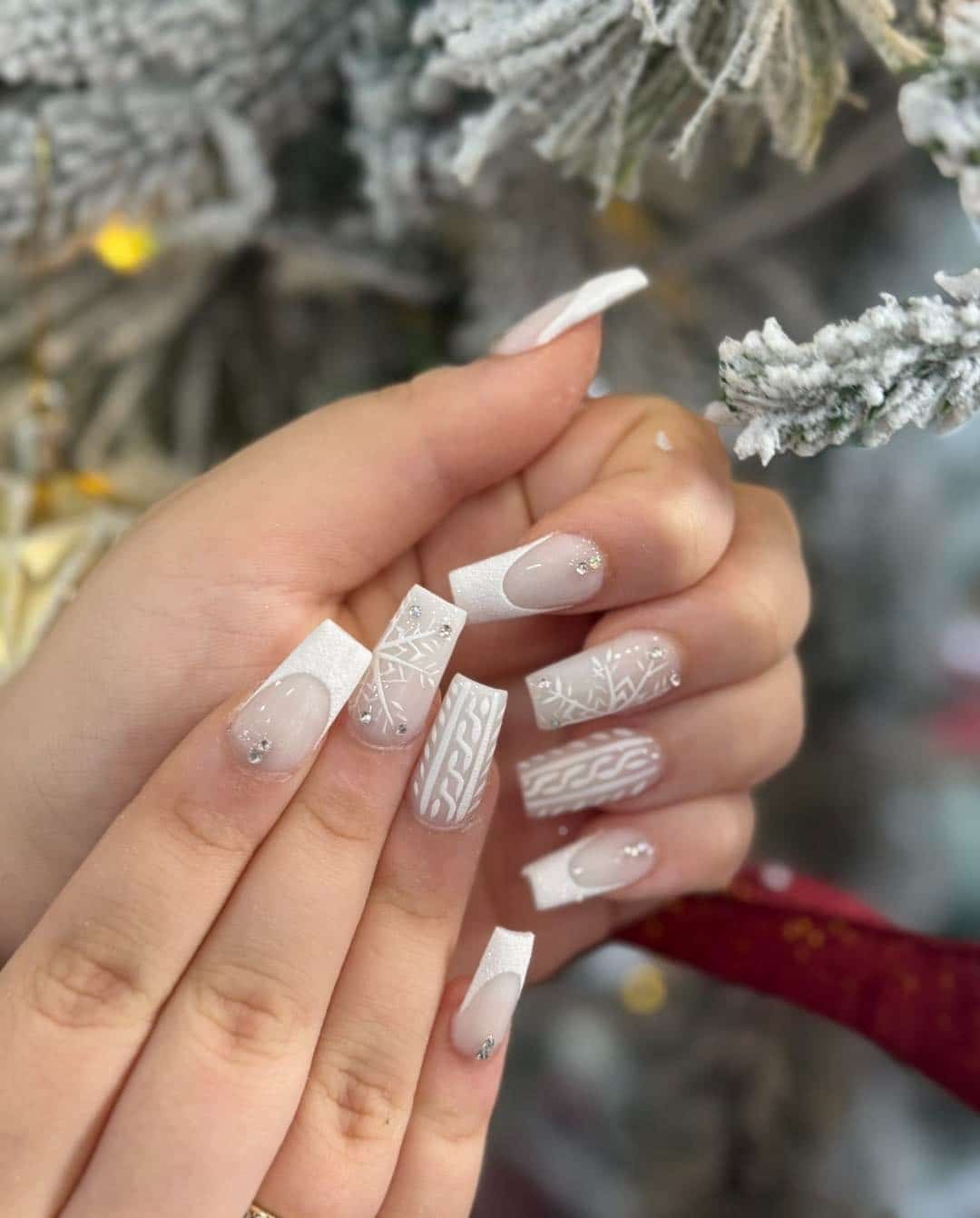 1. White Glitter French Tips with Snowflake Sweater Nails - white winter nail ideas