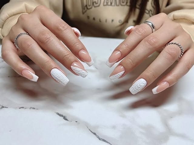 4. Almond White French Tips with Sweater Accents - white winter nail ideas