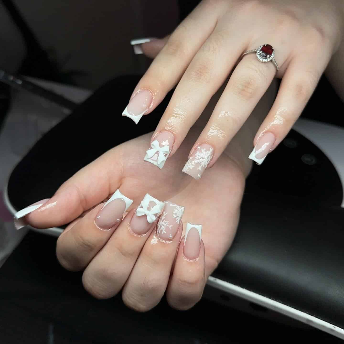 13. White French Tip Bow Accent Nails - white winter nail ideas