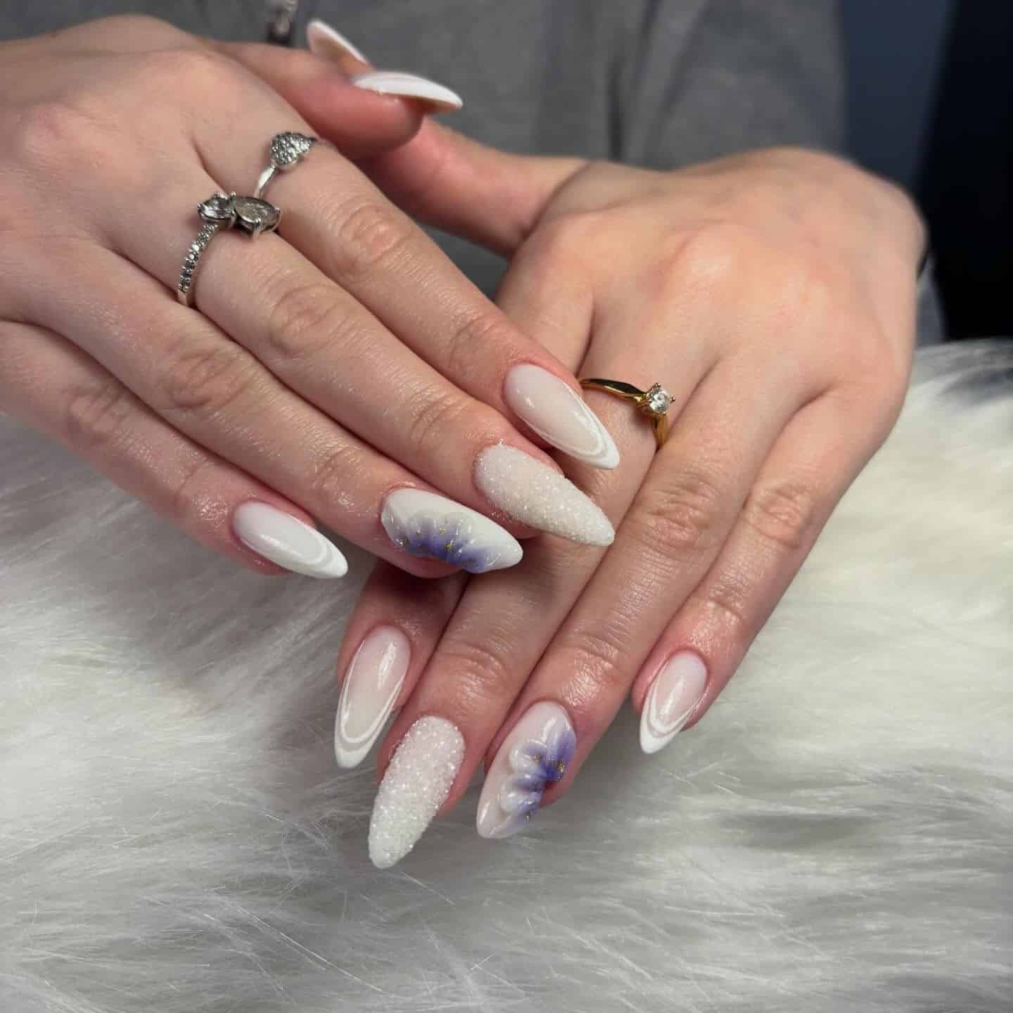 17. White Almond Nails with Icy Blue Floral Accents - white winter nail ideas