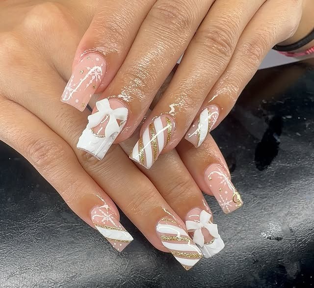 21. White and Gold Gift Bow Winter Coffin Nails - white winter nail ideas