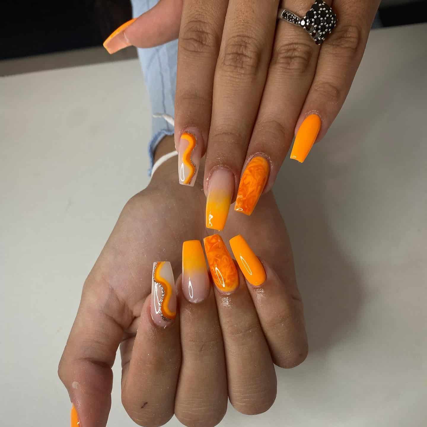 2. Bright Orange Swirl Accent Coffin Nails - orange color nail ideas