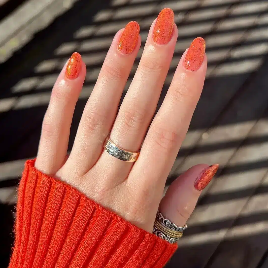 4. Orange Glitter Almond Nails - orange color nail ideas