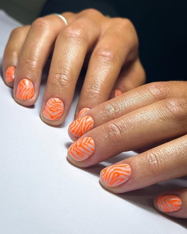 5. Orange Zebra Print Short Nails - orange color nail ideas