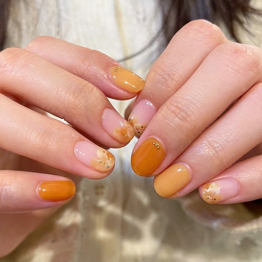6. Amber Orange Floral Accent Nails - orange color nail ideas
