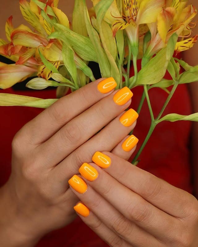 11. Bright Tangerine Short Square Nails - orange color nail ideas