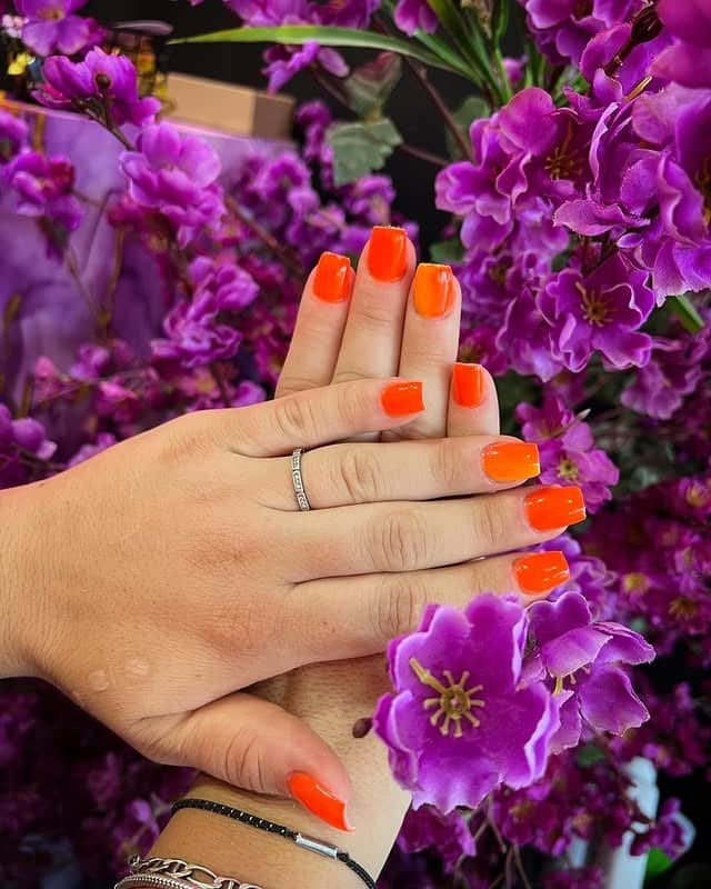 12. Glossy Neon Orange Square Nails - orange color nail ideas