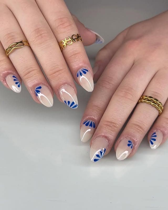 1. Blue Petal French Almond Nails - short spring break nail ideas