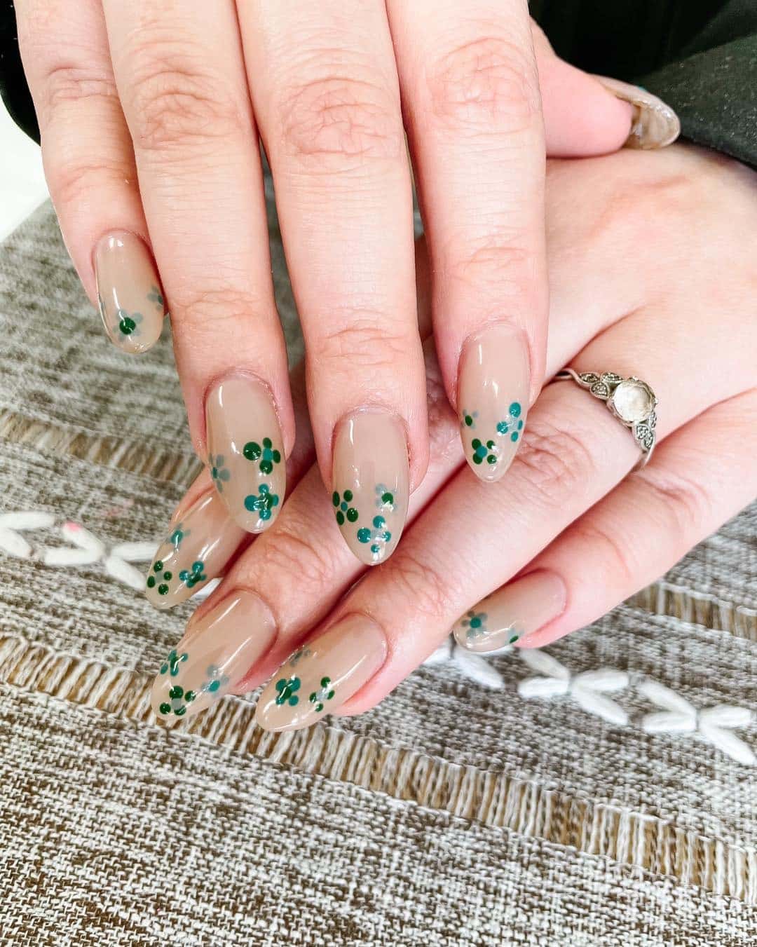 18. Sage Green Floral Nude Almond Nails - short spring break nail ideas