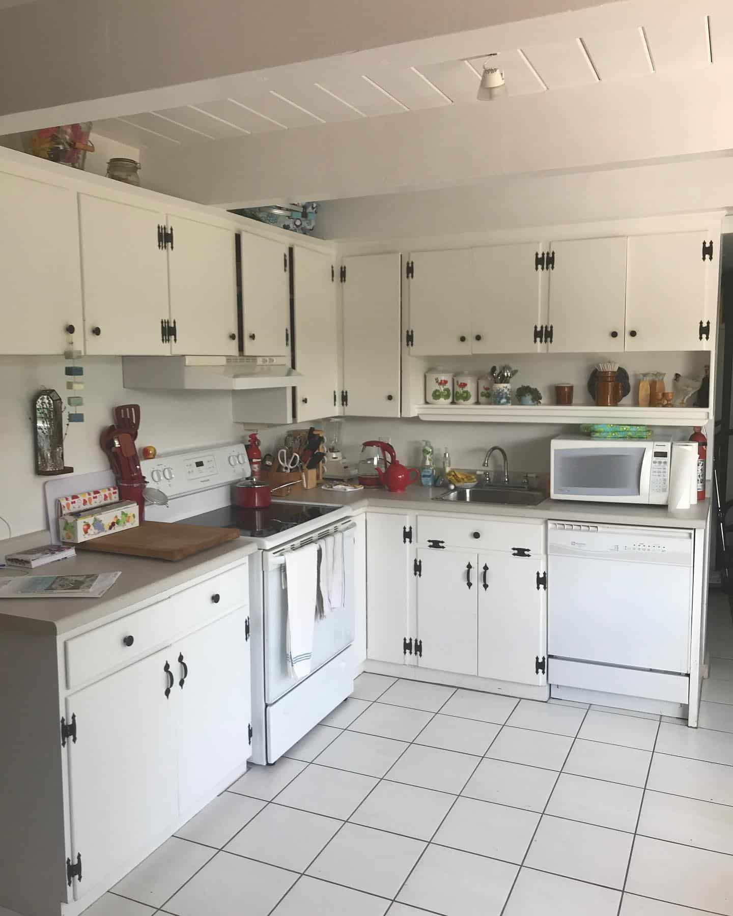 2. Classic White Cottage Kitchen with Vintage Black Hardware - cottage kitchen ideas