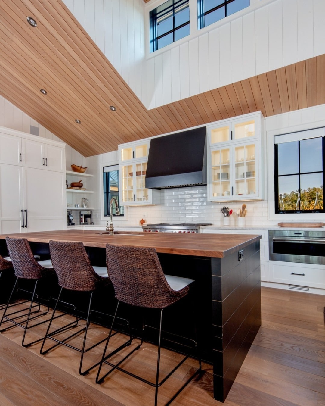 8. White Cottage Kitchen with Black Island and Wood Ceiling - cottage kitchen ideas