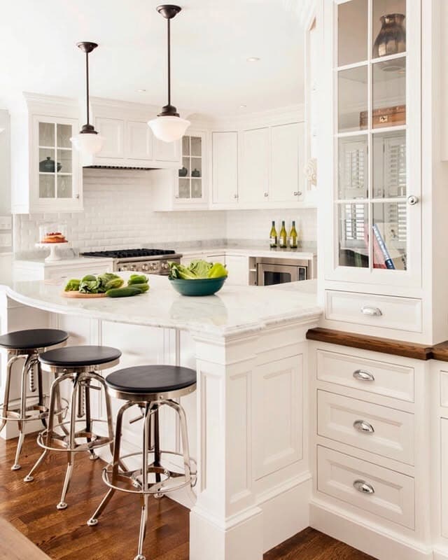15. White Cottage Kitchen with Marble Counters and Classic Lighting - cottage kitchen ideas