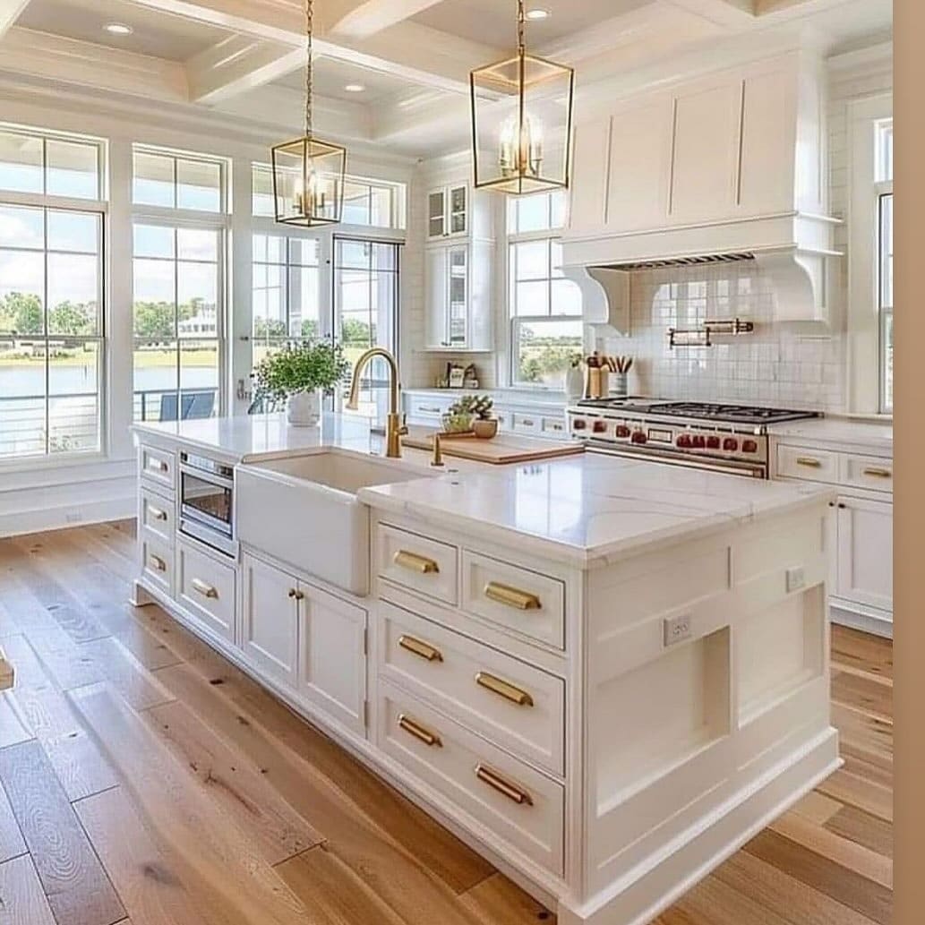 20. White Cottage Kitchen with Gold Hardware and Waterfront Views - cottage kitchen ideas