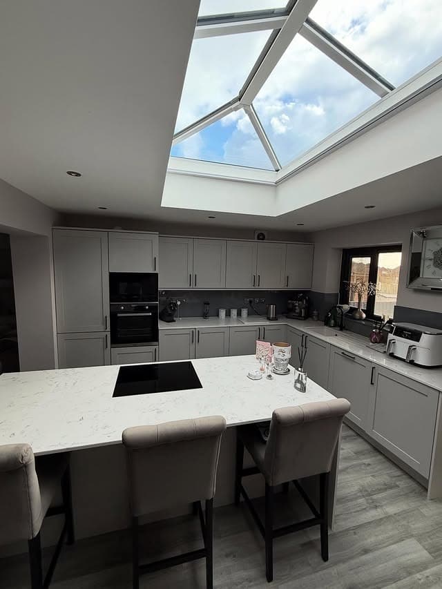 10. Light Grey Kitchen With Skylight and Oversized Island - light grey kitchen ideas