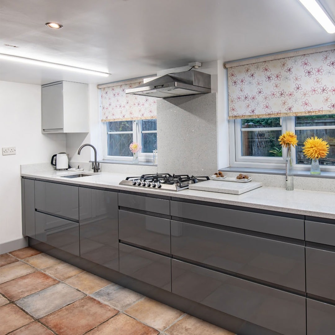 13. Gloss Dark Grey Kitchen With White Countertops - light grey kitchen ideas
