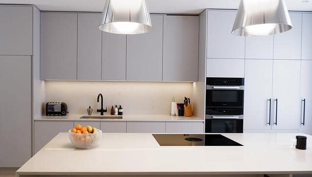 21. Minimalist Light Grey Kitchen With Waterfall Island - light grey kitchen ideas