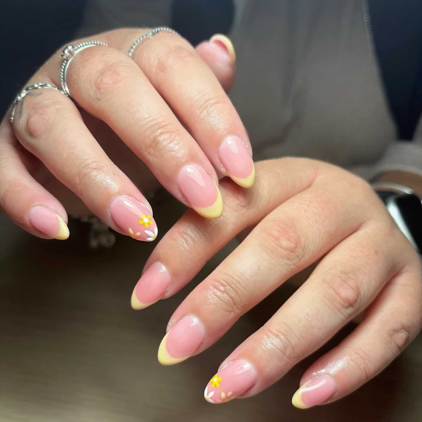 9. Pastel Yellow Floral French Almond Nails - yellow nail ideas