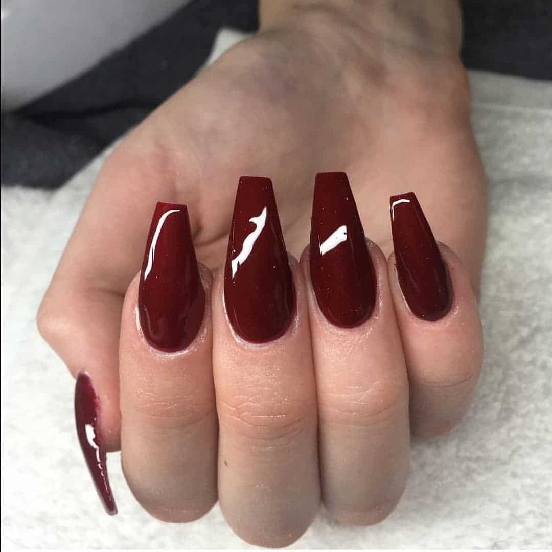6. Dark Red Coffin Nails with Glass-Like Shine - dark red coffin nail ideas