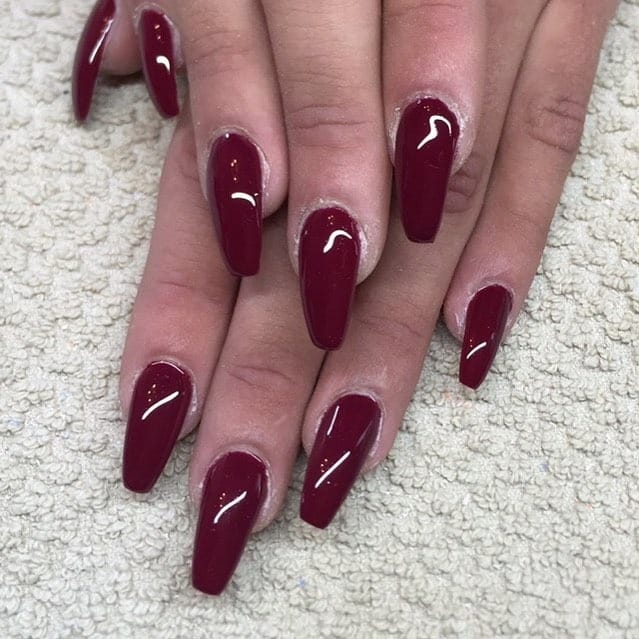 11. Glossy Berry Red Coffin Nails - dark red coffin nail ideas