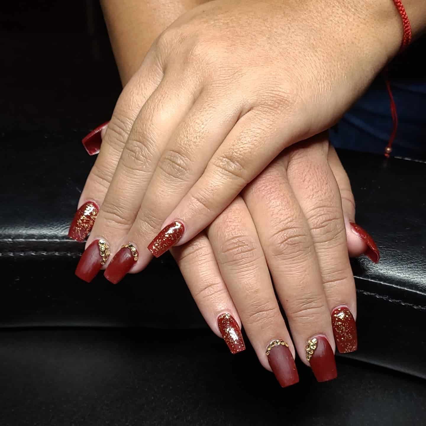 18. Matte Brick Red Coffin Nails with Gold Glitter - dark red coffin nail ideas