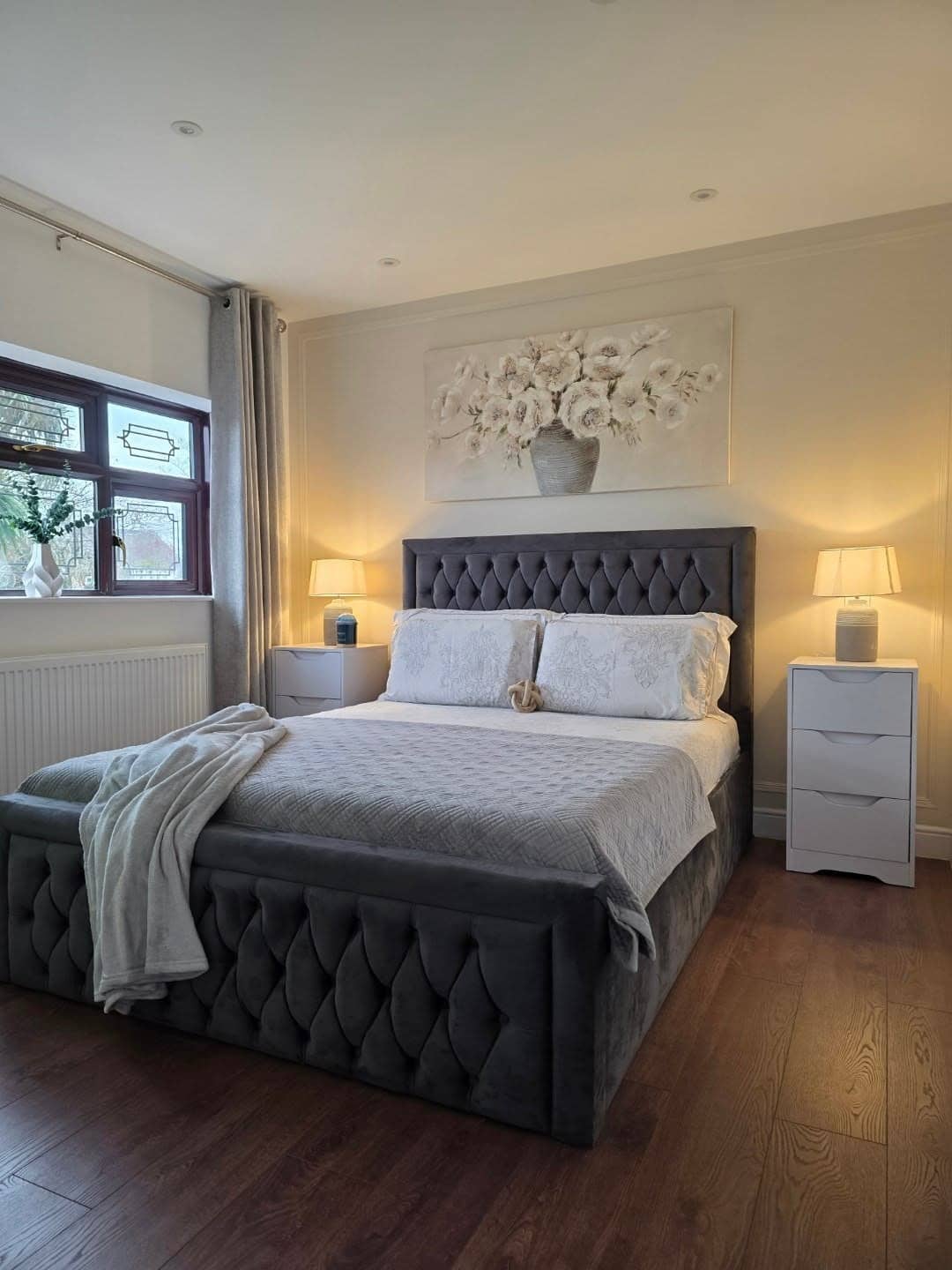 5. Charcoal and Soft White Tufted Bedroom Retreat - neutral bedroom ideas