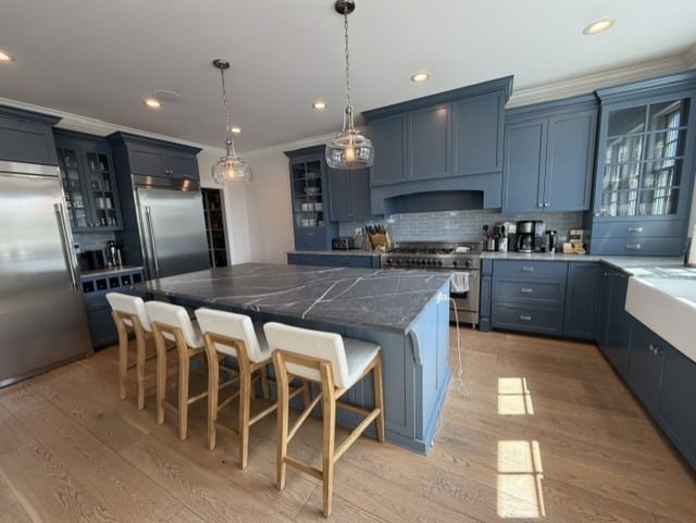 1. Slate Blue Kitchen Cabinets with Charcoal Waterfall Island - blue kitchen cabinets ideas