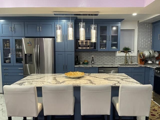 21. Steel Blue Kitchen Cabinets with Waterfall Quartz Island - blue kitchen cabinets ideas