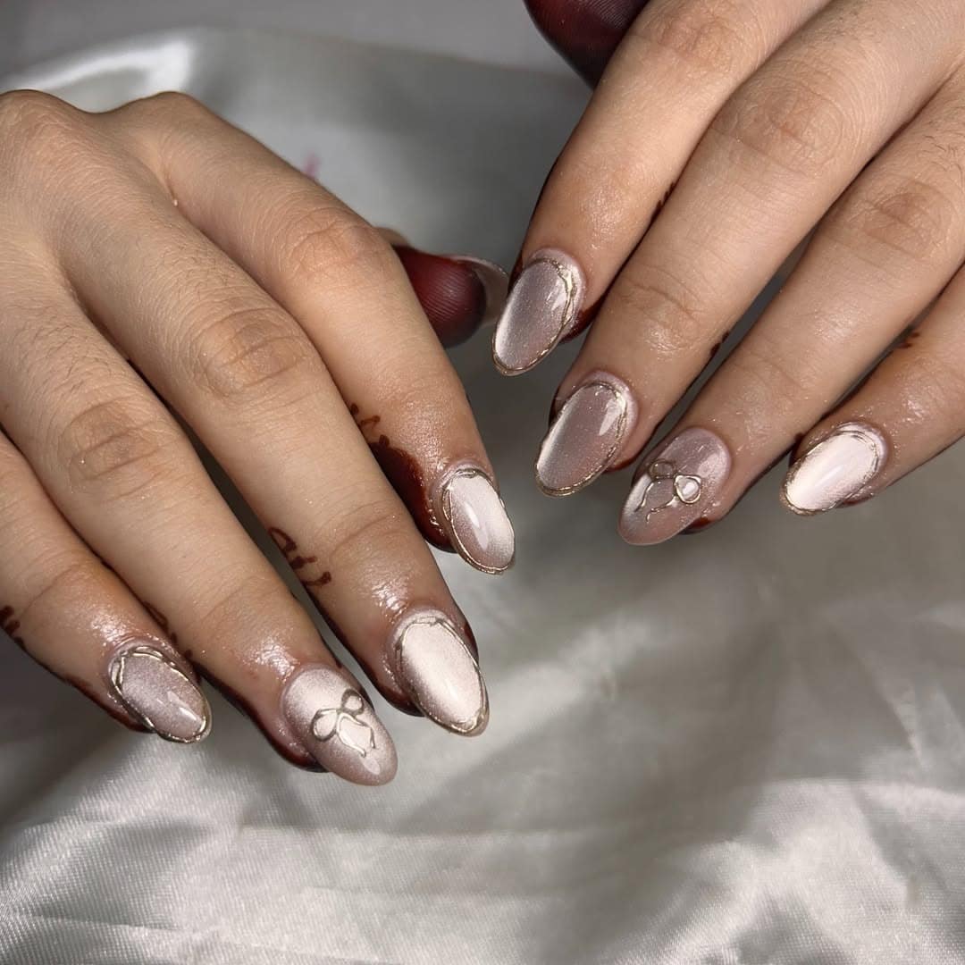 10. Champagne Chrome Bow Accent Nails - chrome nail ideas