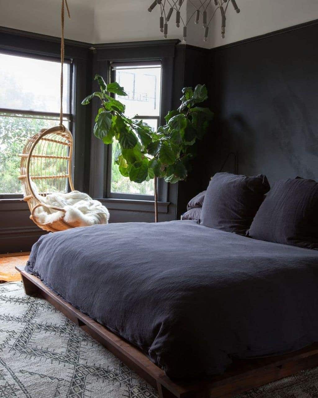 20. Matte Black Bedroom with Indoor Plants and Natural Light - dark bedroom ideas