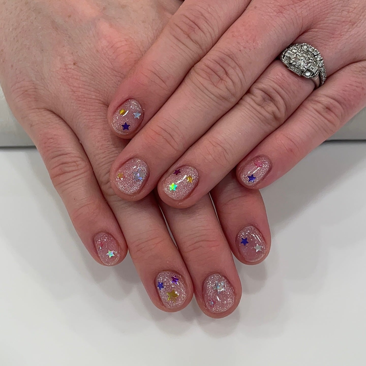 3. Nude Glitter Star Confetti Short Nails - glitter nail ideas