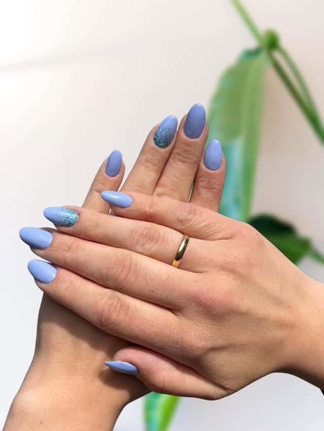 11. Periwinkle Blue Glitter Accent Almond Nails - glitter nail ideas