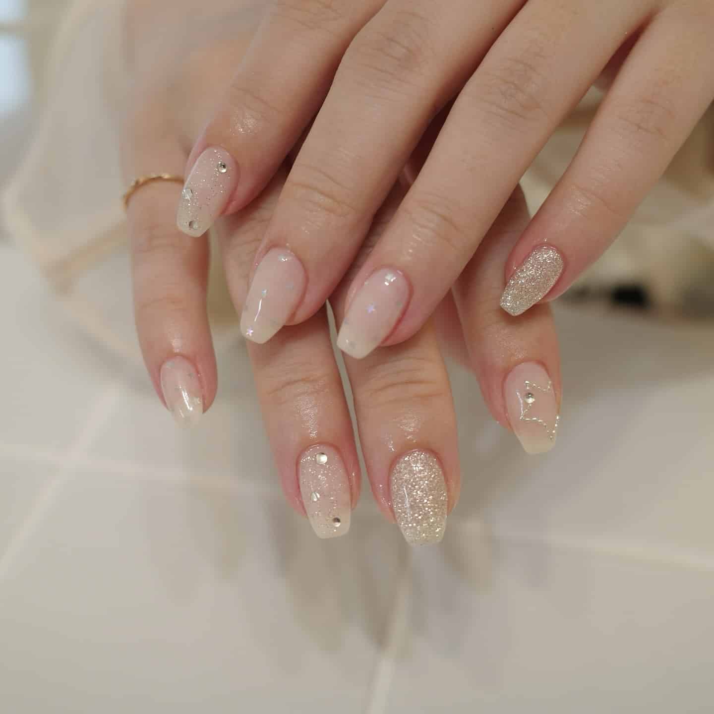 15. Champagne Glitter Ombre Coffin Nails with Rhinestones - glitter nail ideas
