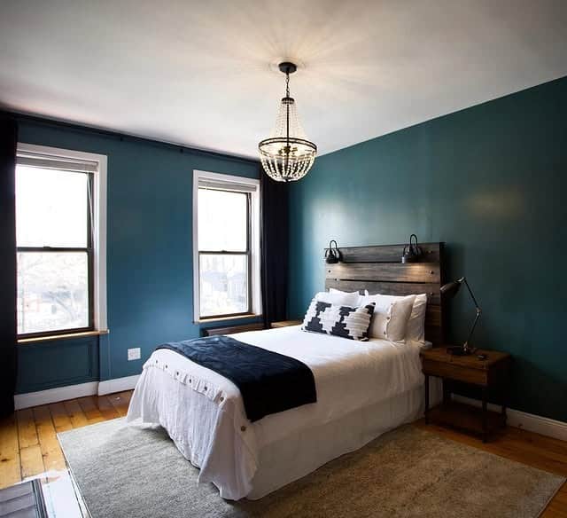 1. Moody Teal Bedroom With Rustic Wood Accents - teal bedroom ideas